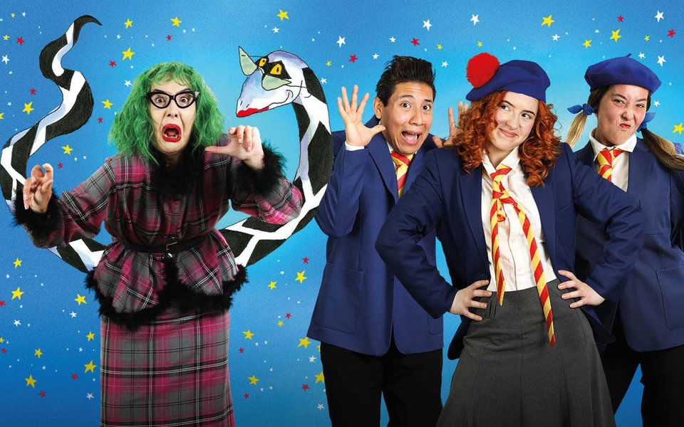 A woman with green hair is surrounded by a black and white snake. There are children in school uniform, one is scared, one is unimpressed.