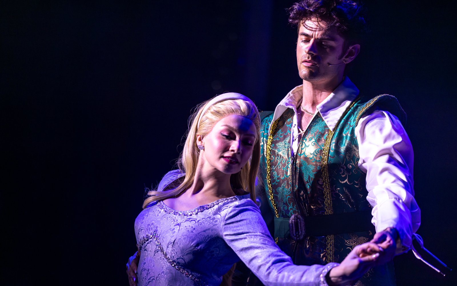 Princess Rose looks to the side, smiling, with her hand held out. Prince Ken stands behind her, looking at her, holding her outstretched hand.