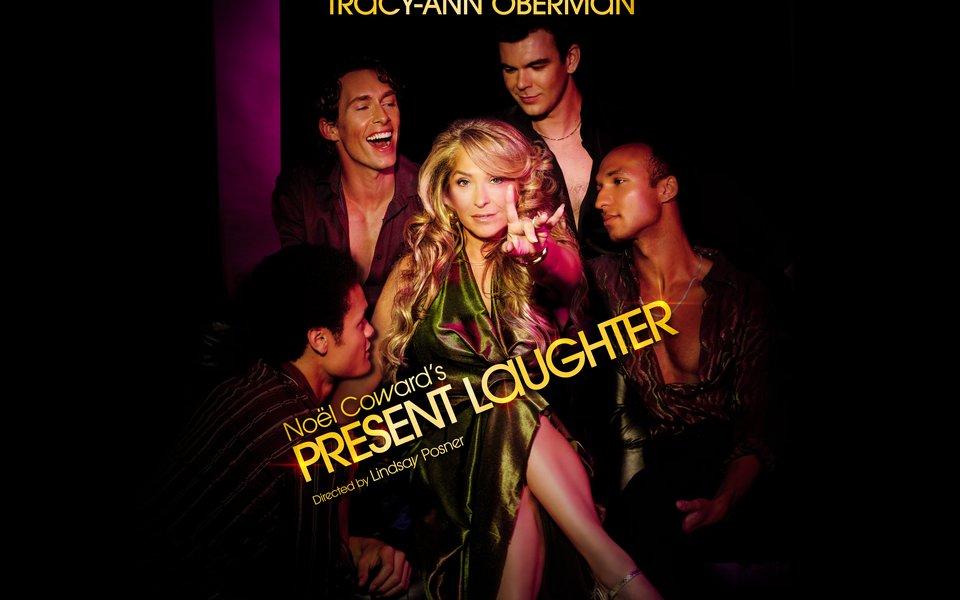 A glamorous woman in a gold dress sits between men who are looking at her in admiration