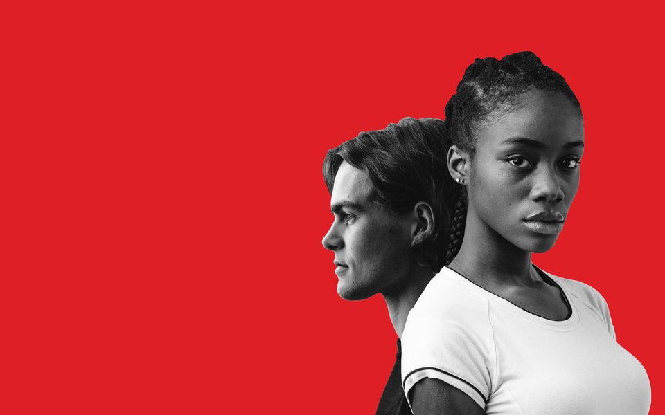 A black woman and a white man against a red background