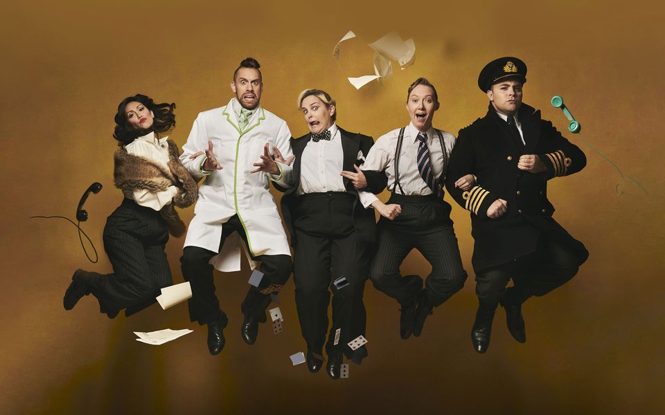 Five men and women wearing suits, they are jumping in the air together with papers and telephones
