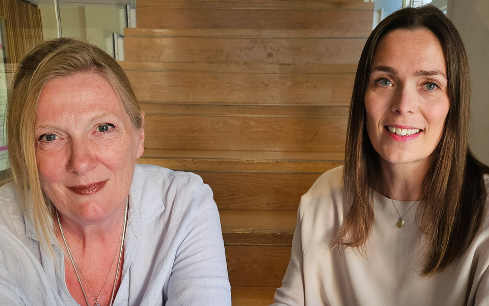 Two women sat together on a staircase