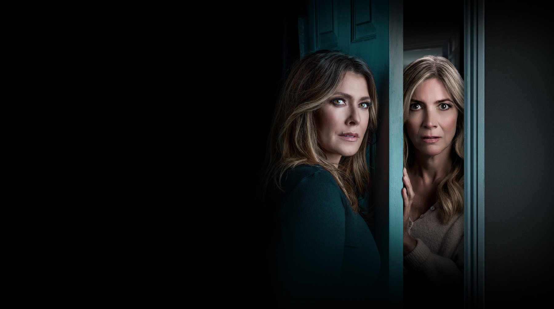 Two women standing either side of a door, they look scared