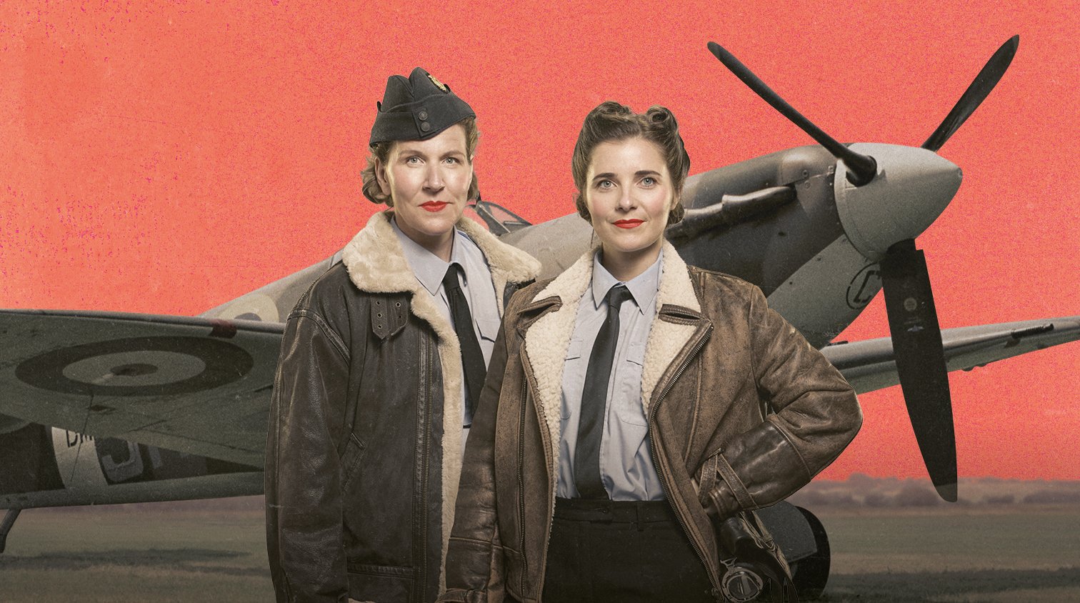 Two women in World War 2 bomber jackets stand in front of a propeller plane