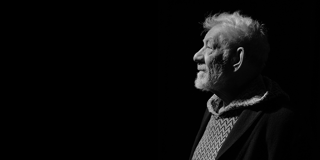 Sir Ian McKellen looks into the distance, in black and white.